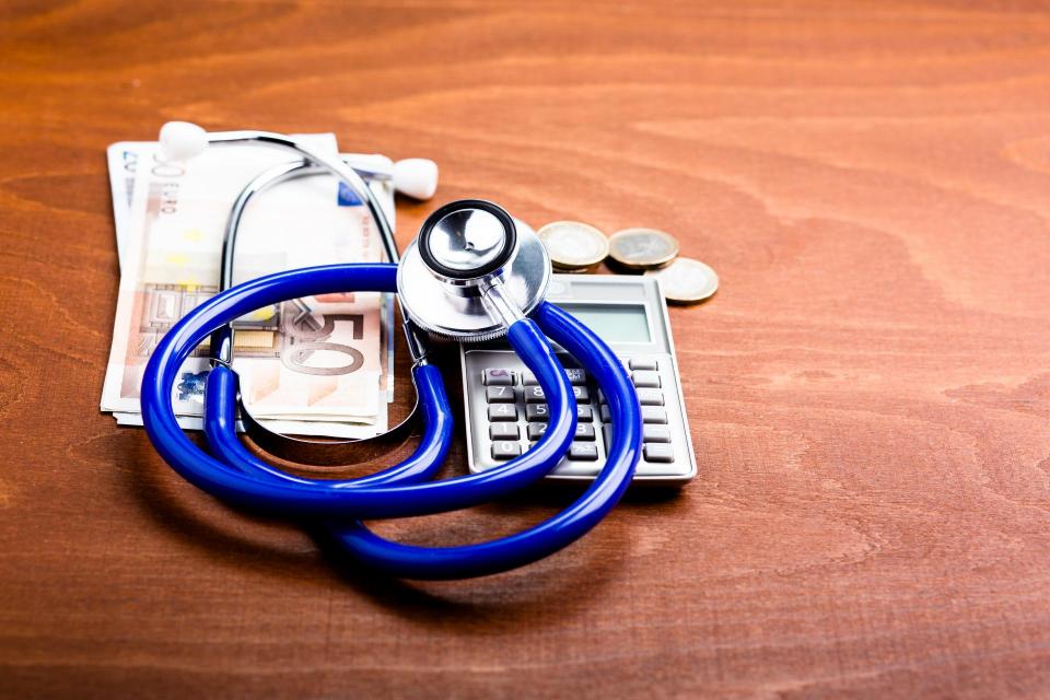 Stethoscope on a calculator and money