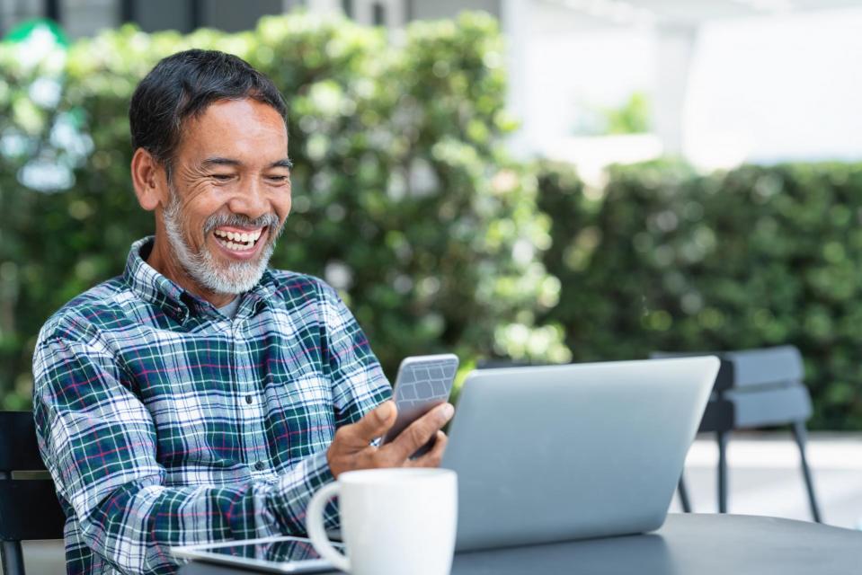 Happy man on laptop.