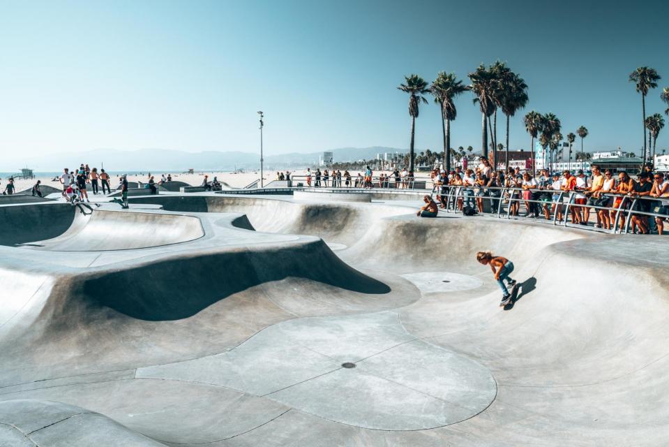 People skating at the skatepark showing different tricks.