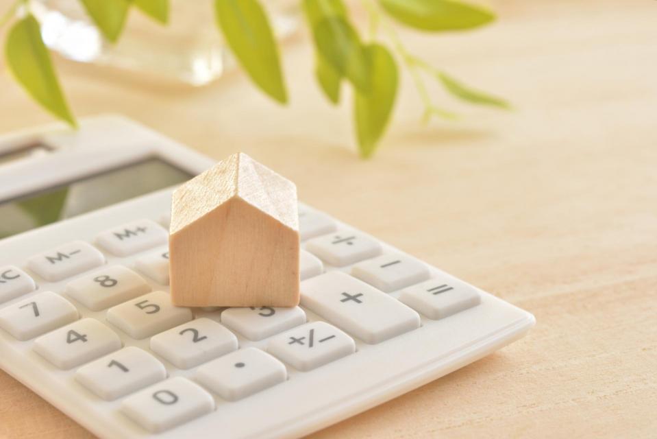 Calculator with small wooden house