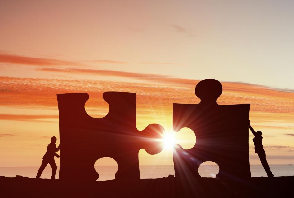Two individuals cooperating to succeed