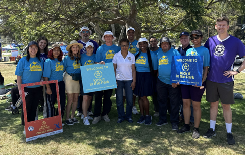 LA City Mayor and a diverse group of volunteers at the park during a fan experience event. 