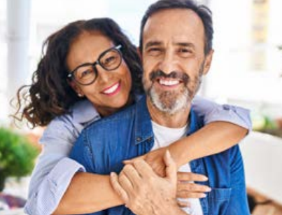 Middle aged couple smiling and hugging