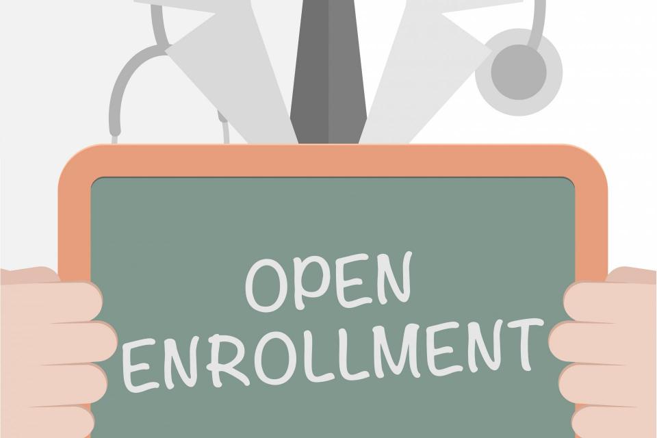 Image of doctor holding open enrollment sign