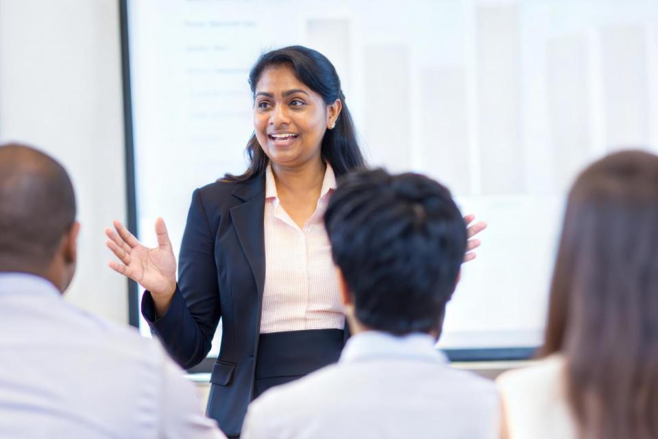 Presenter addressing a group of attendees