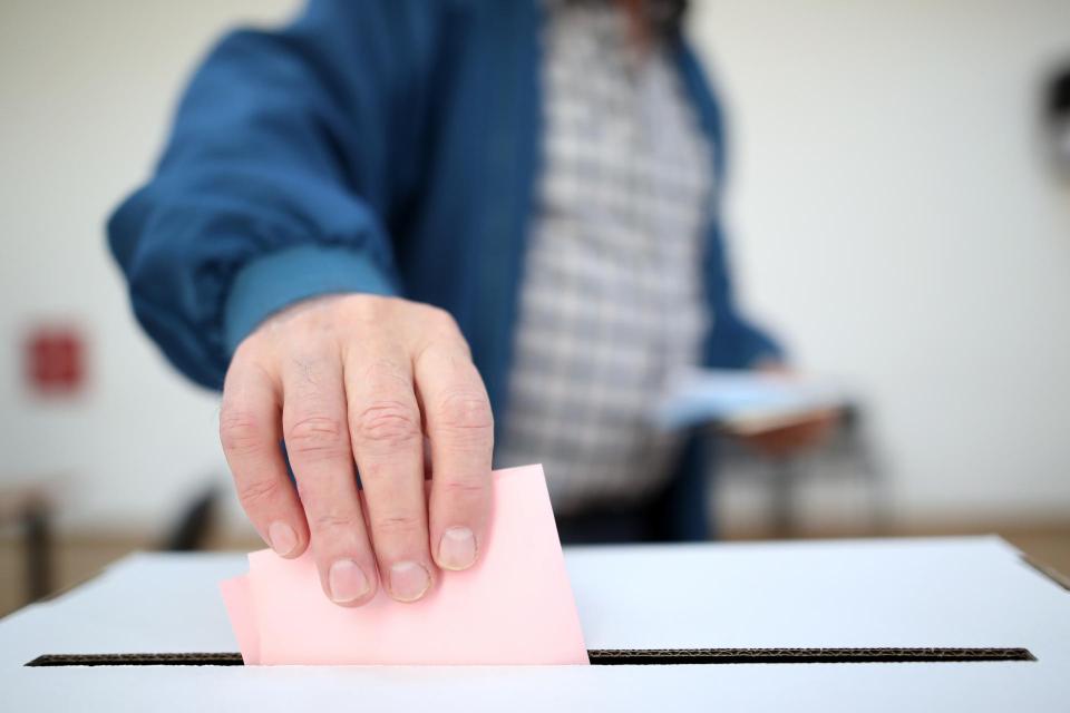Man casting a ballot.