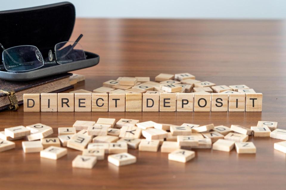 Wooden blocks with words Direct deposit  spelled out.