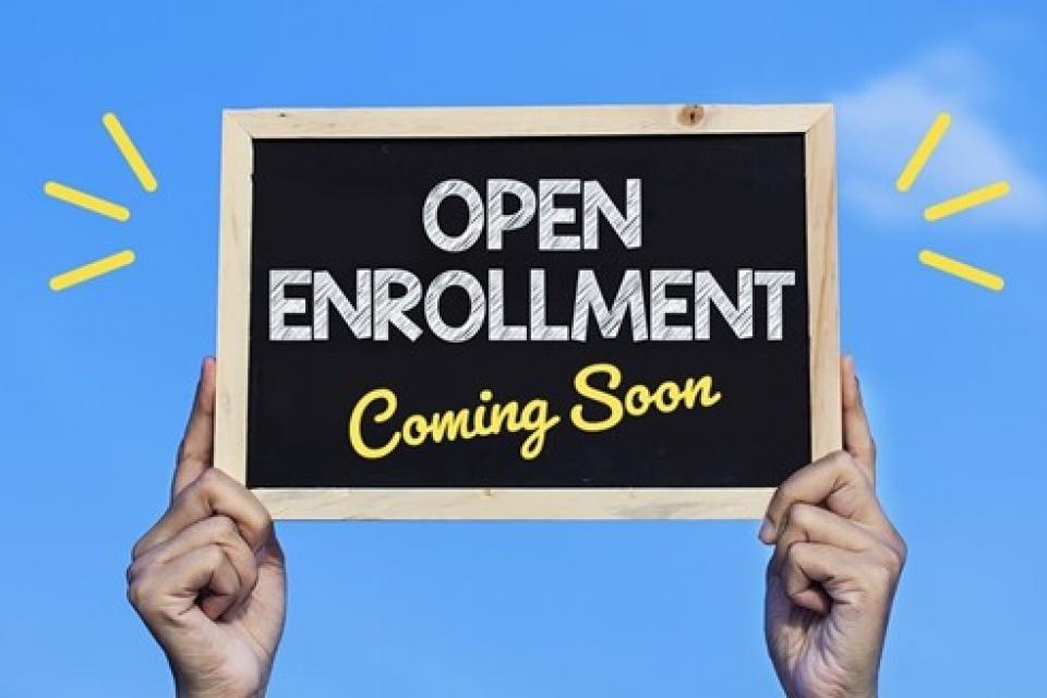 Chalkboard sign that reads "Open Enrollment Coming Soon".