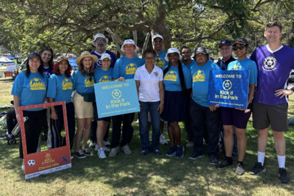 LA City Mayor and a diverse group of volunteers at the park during a fan experience event. 
