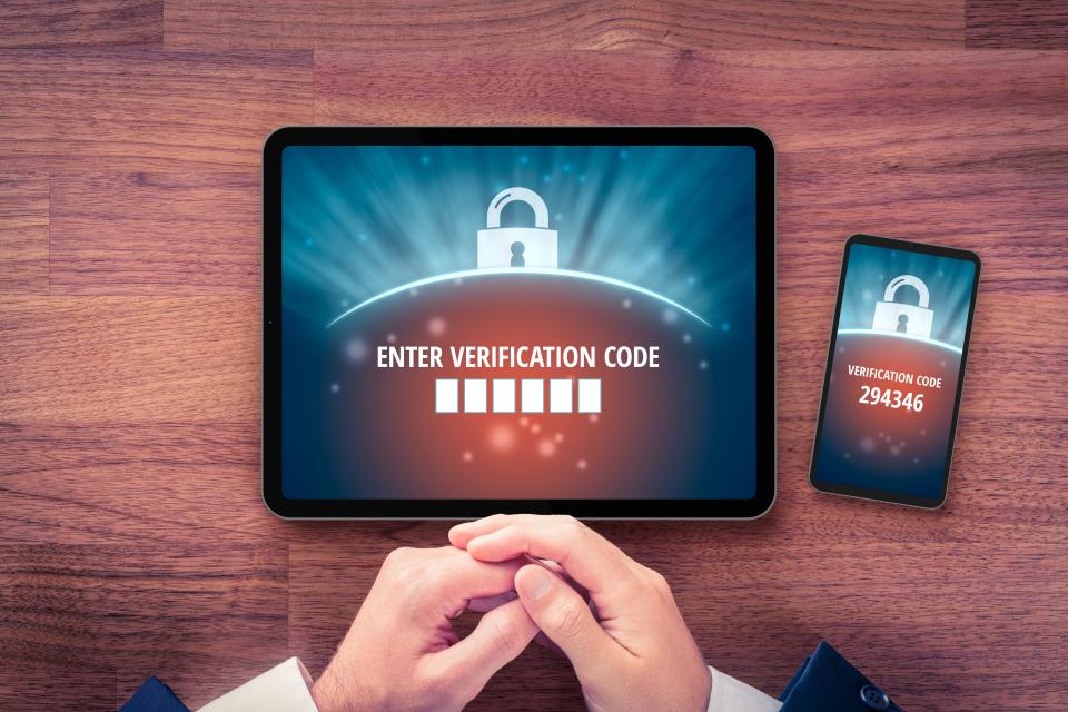 Two-factor authentication image of a laptop and cell phone