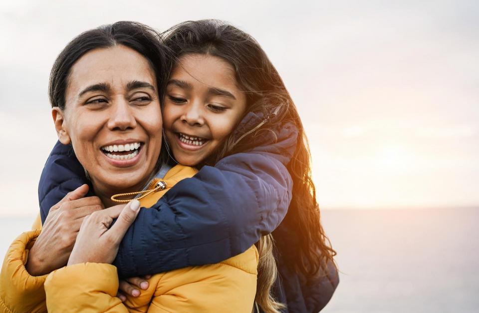 Mother and daughter hugging