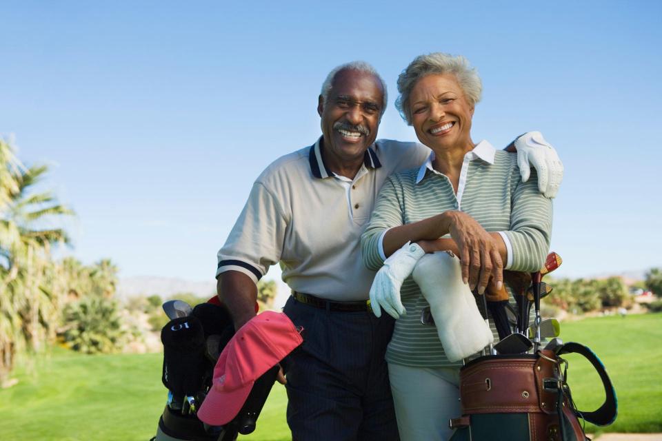 Happy senior couple in golf course
