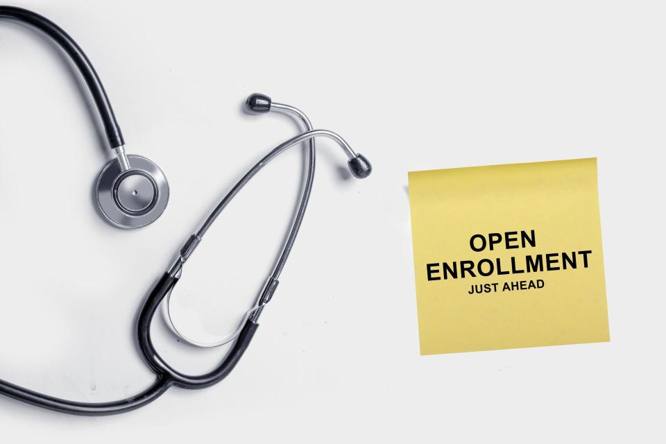 Image of stethoscope accompanied by an Open Enrollment Ahead sticky note.