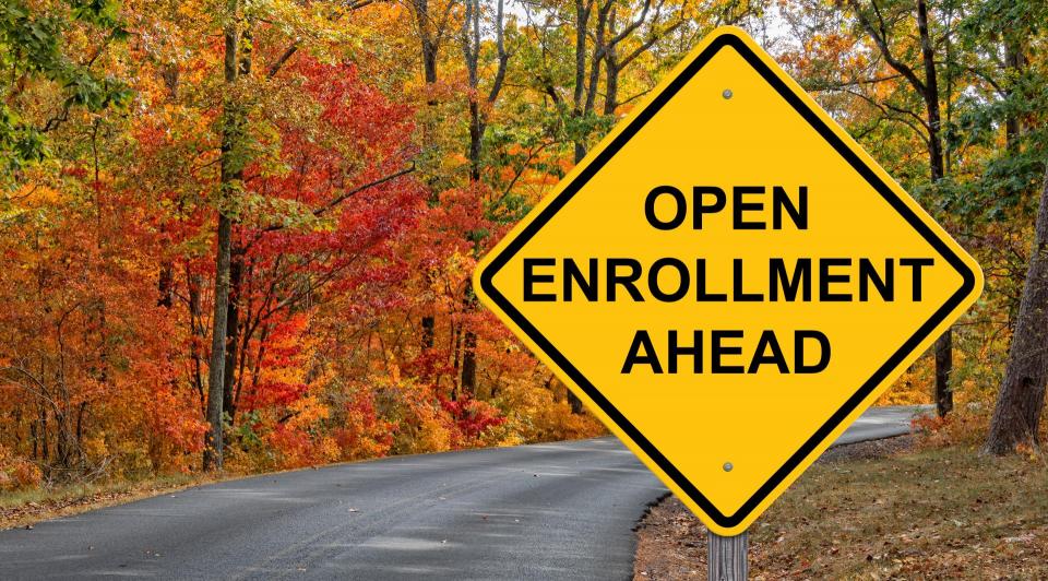 Road sign saying "Open Enrollment Ahead"