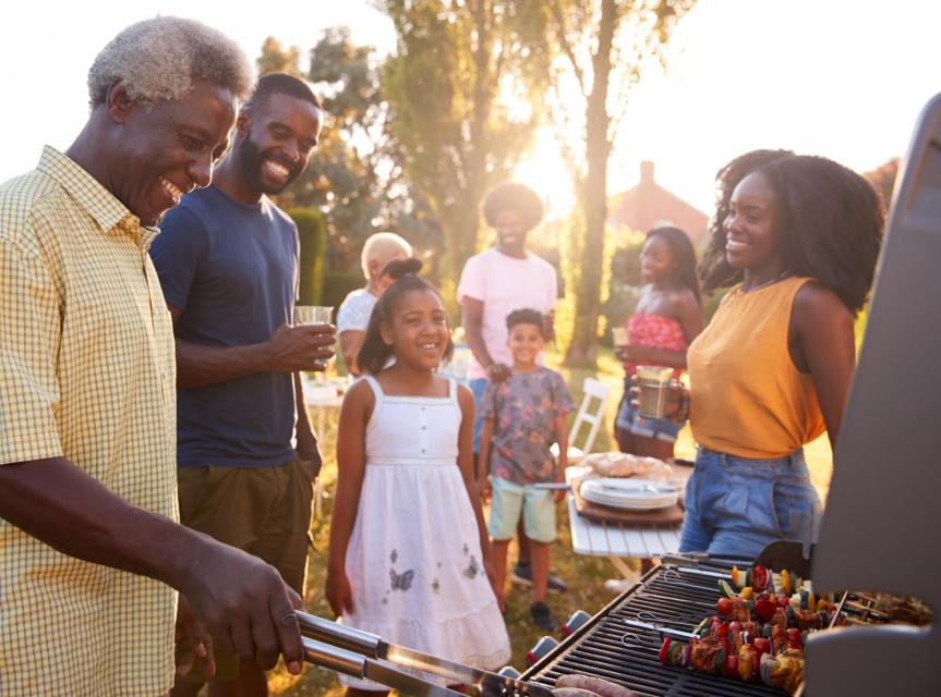 Joyful family enjoying a backyard barbeque