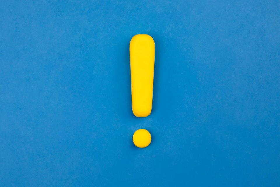Yellow exclamation point inside a blue box
