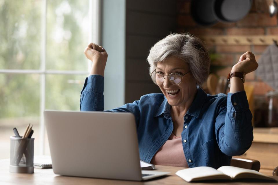 Woman excited in front of computer screen