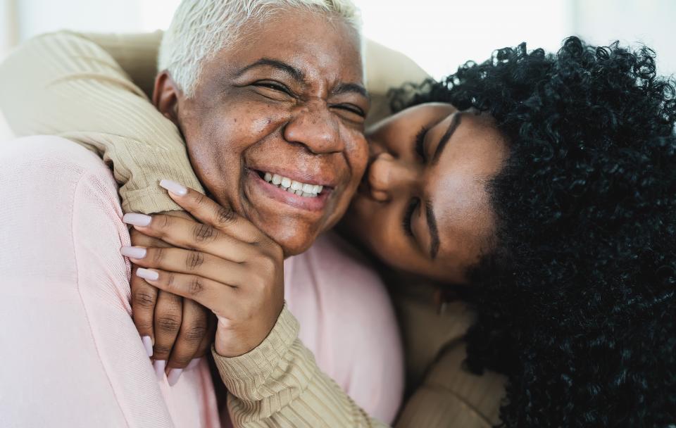 Senior being hugged  by a loved one