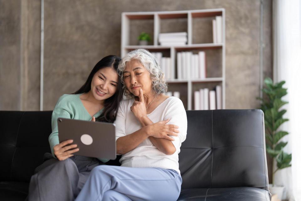 Mother and daughter viewing an tablet device 