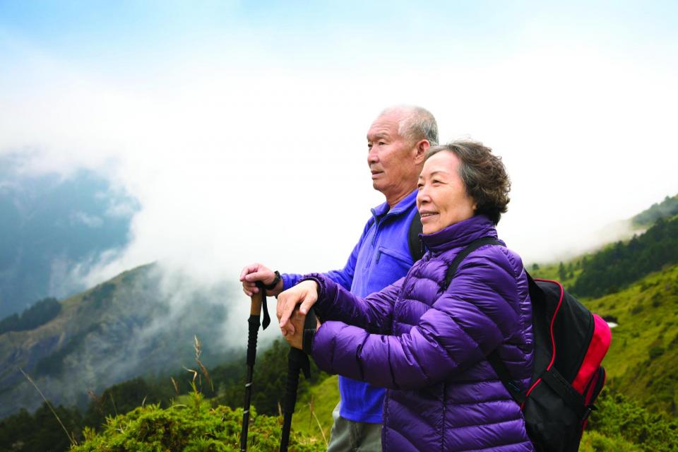 Couple hiking on a lush mountain