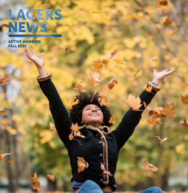 Woman throwing leaves in the air smiling